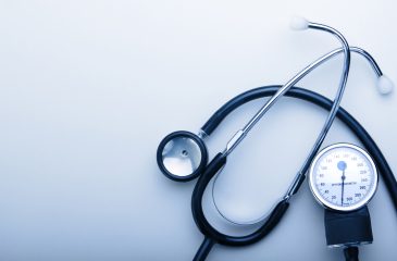 stethoscope on blue background with space for simple text